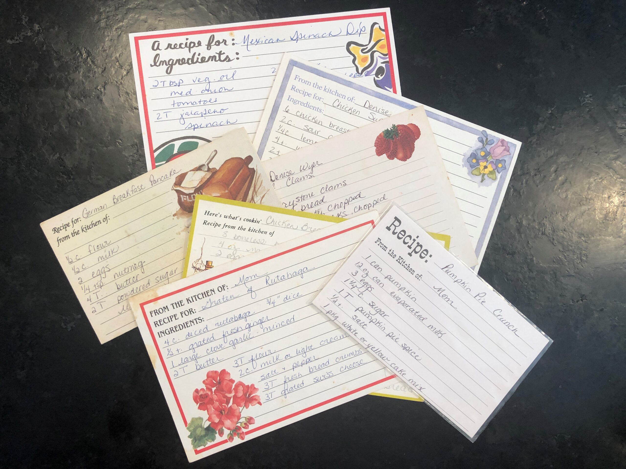 Group of recipe cards being added to a fundraising cookbook