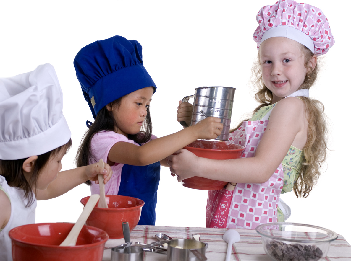 Kids playing in the kitchen using their fundraising cookbook