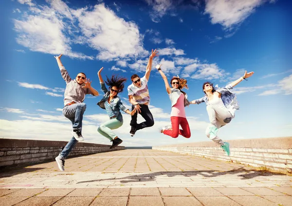 youth group members jumping for joy over their cookbook fundraiser
